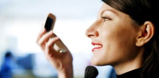 Top 10 Reasons Why Physical Appearance Is So Important? Businesswoman applying makeup